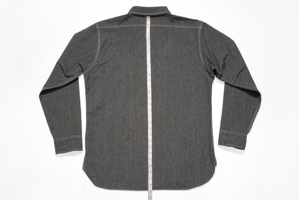 Back view of a gray shirt with measurement tape