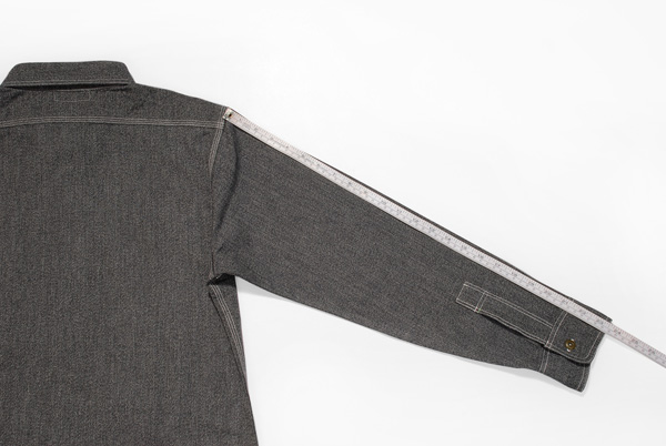 Measuring sleeve length of gray jacket